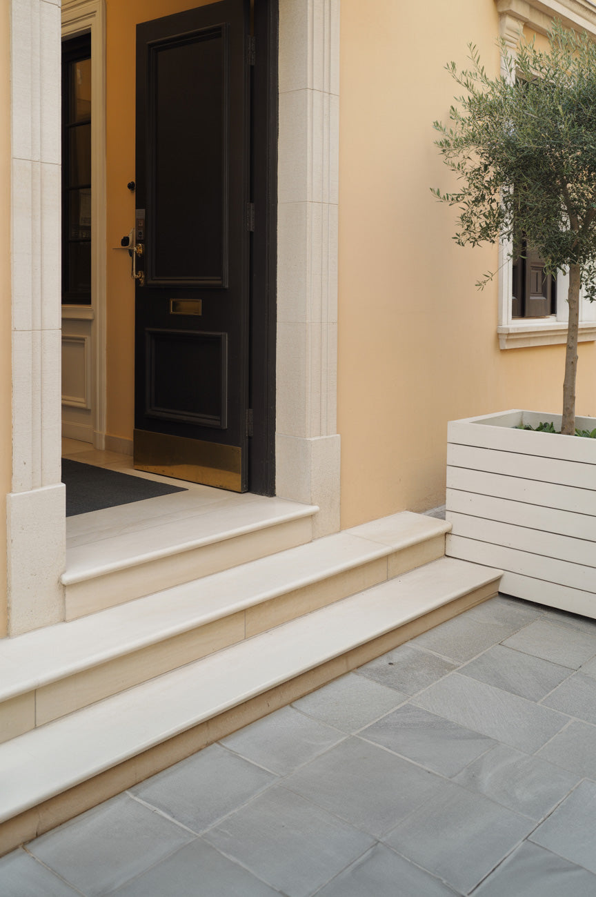 Elegant city entry with stone steps and black door
