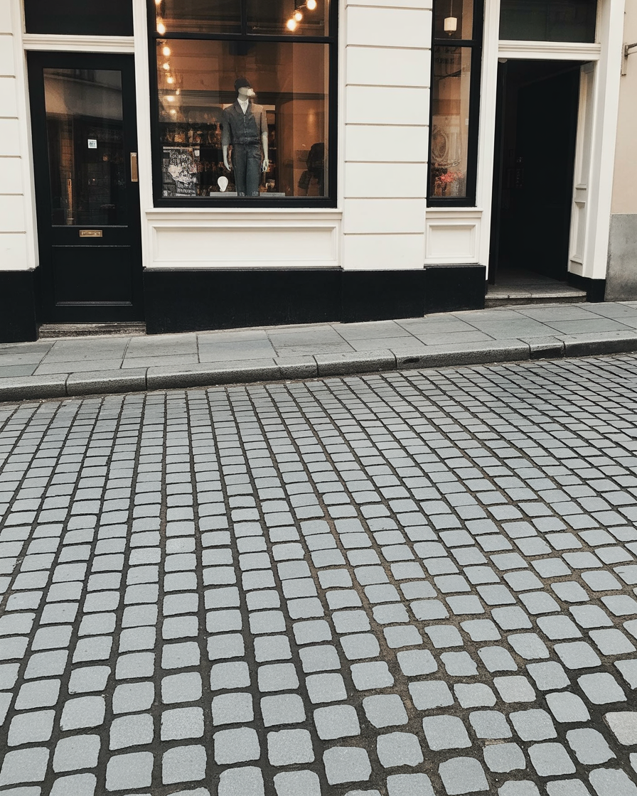 Cobblestone street with classic boutique storefront and window display