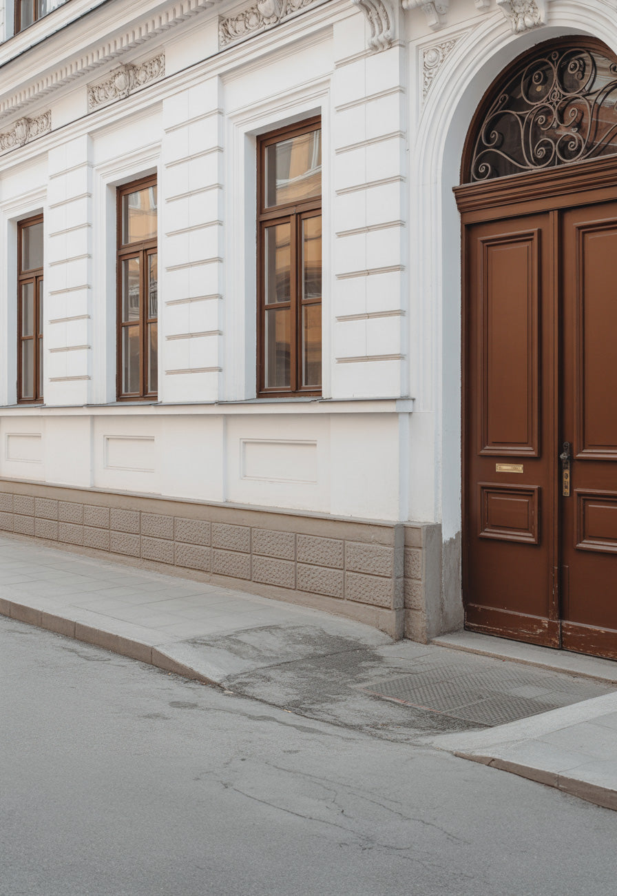 Classic European white facade with arched wooden door
