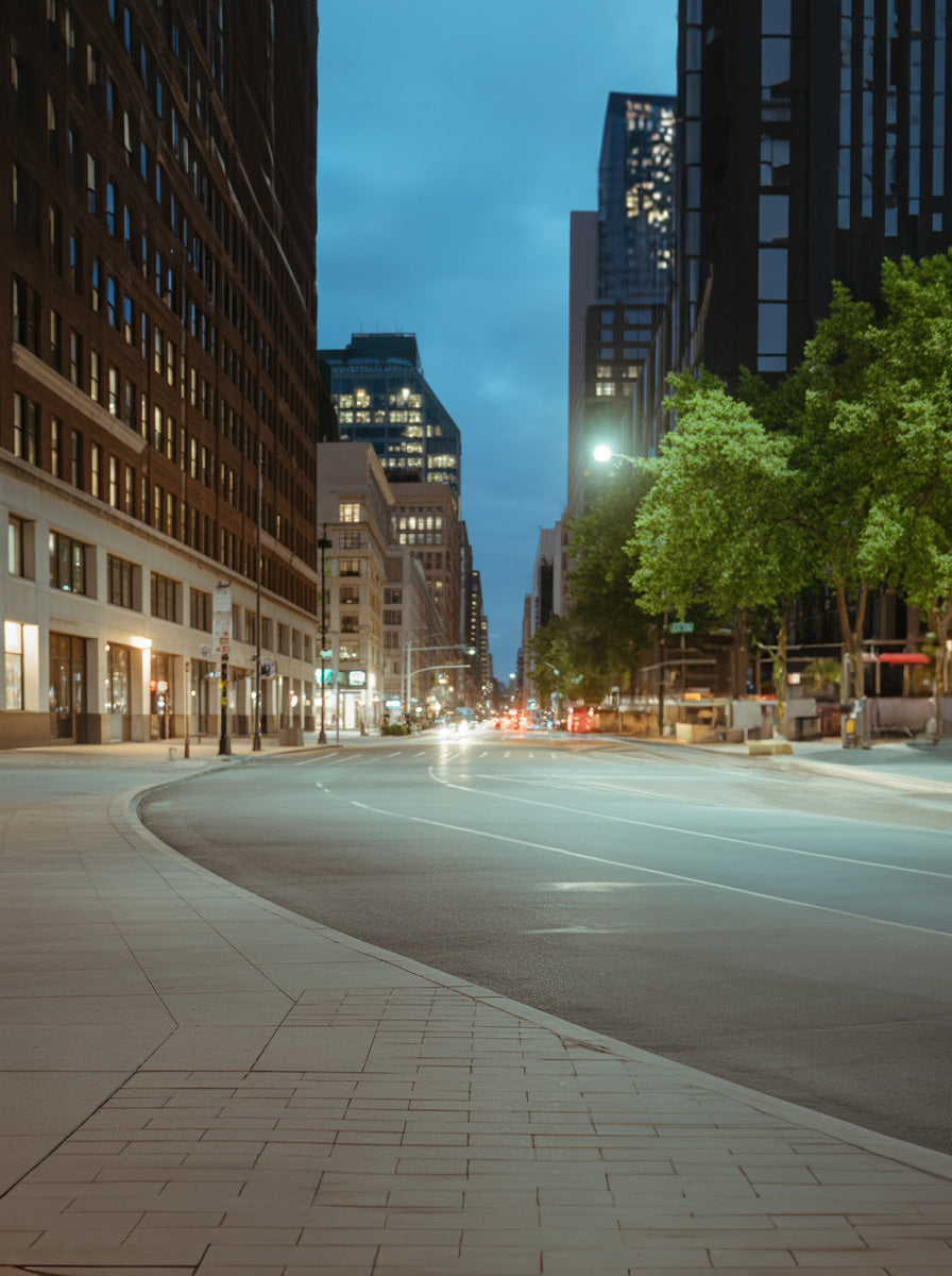 Quiet downtown avenue at blue hour with glowing city lights