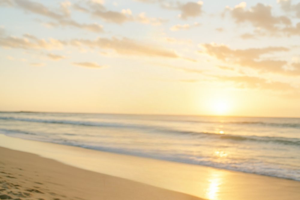 Golden sunset glow on sandy shoreline