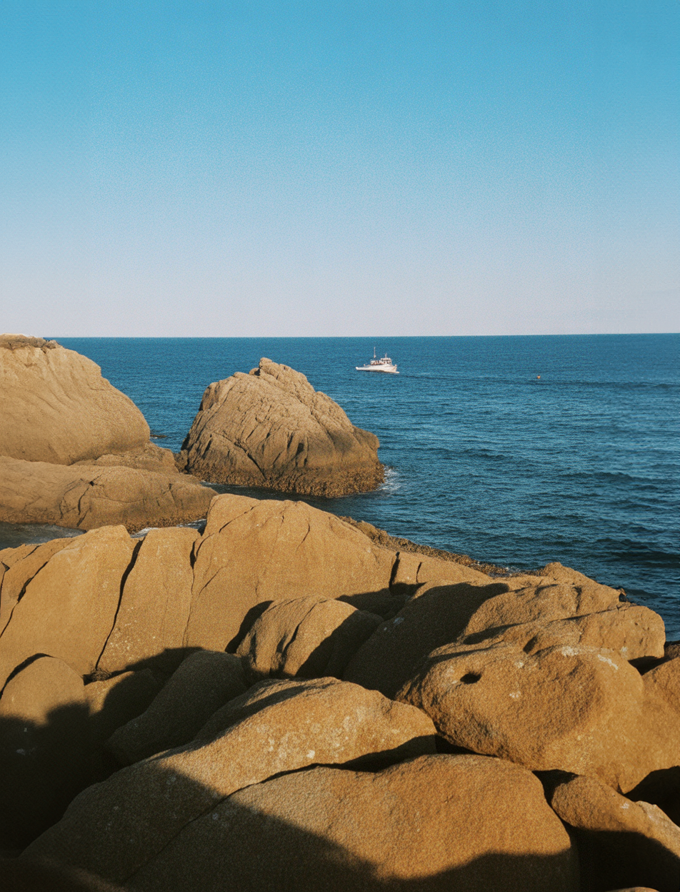 Rocky coastline with blue ocean and clear sky