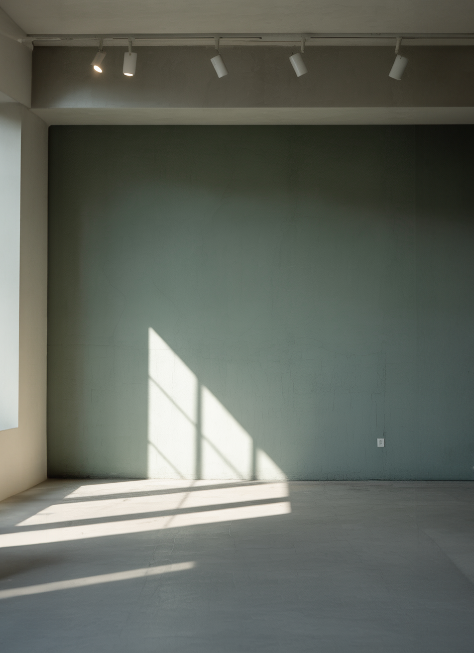 Minimalist interior with green accent wall and sunlight