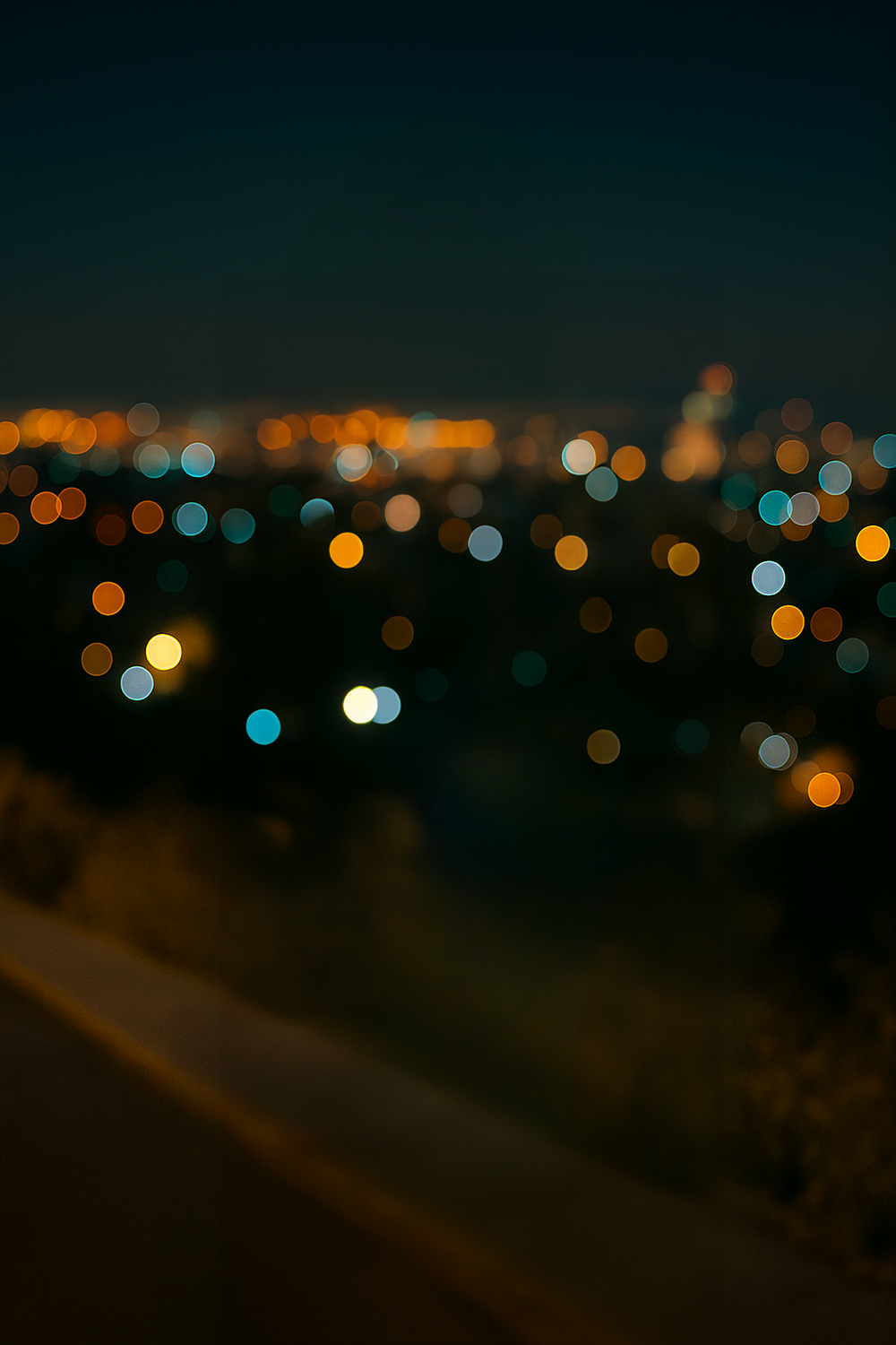 City skyline with glowing bokeh lights after dusk